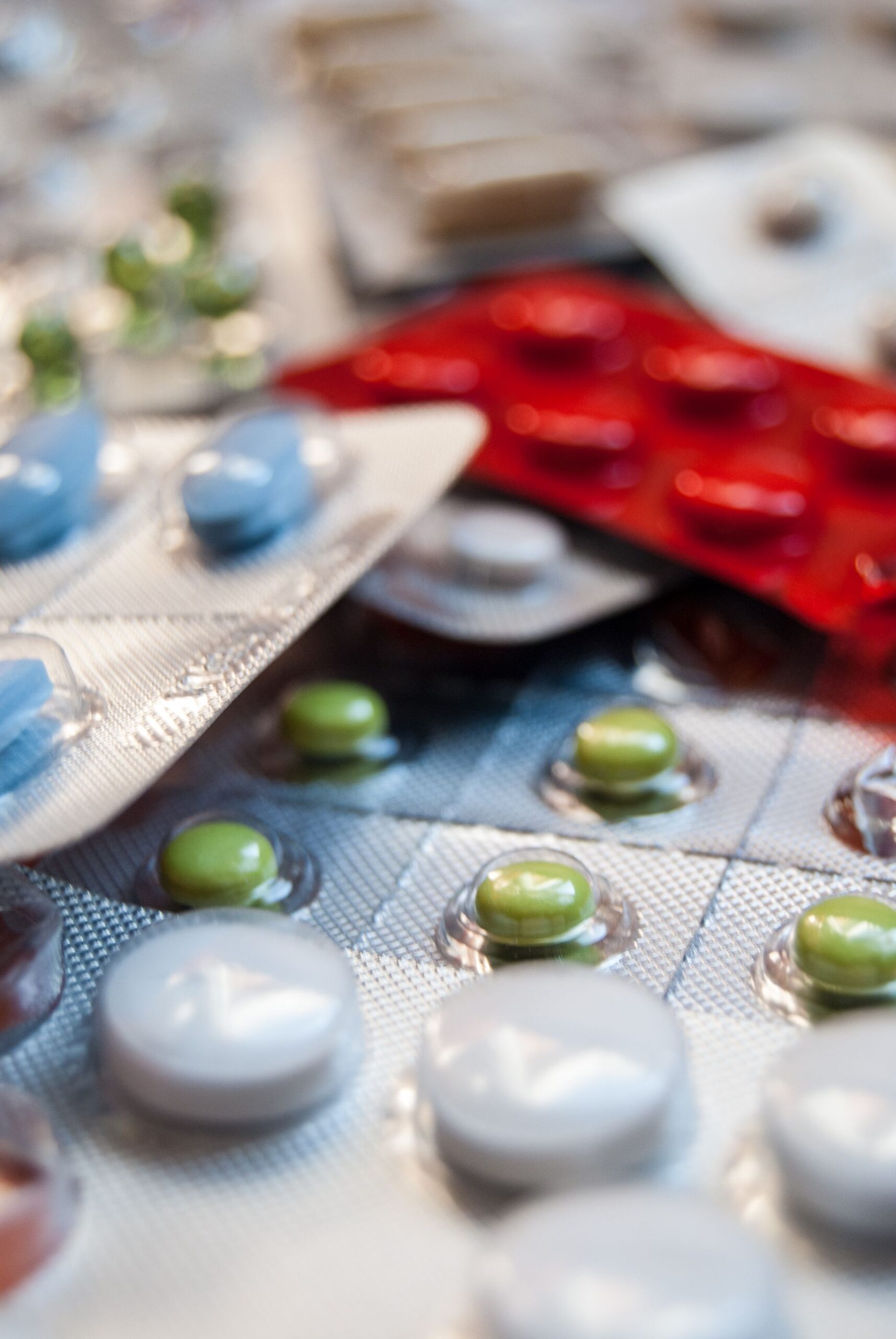 Close-up of various prescription pills in blister packs, highlighting medication diversity.